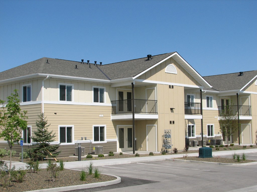a building with two stories and a street in front of it