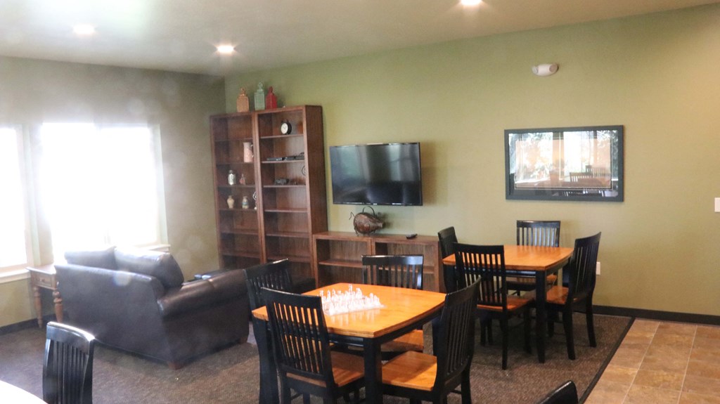 a dining room and living room with a table and chairs