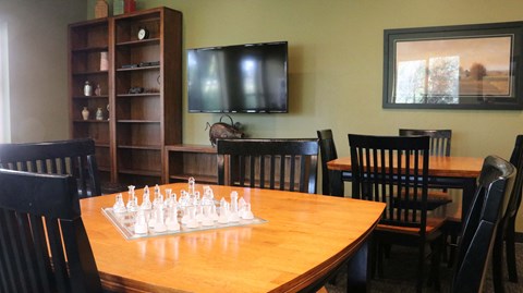 a game room with a chess board on a table