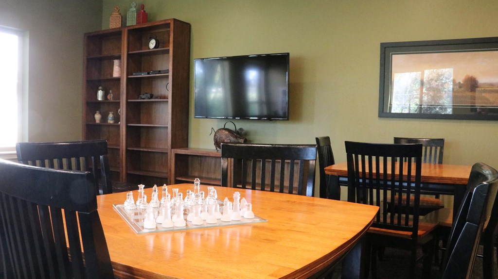 a board game room with a table with chess pieces