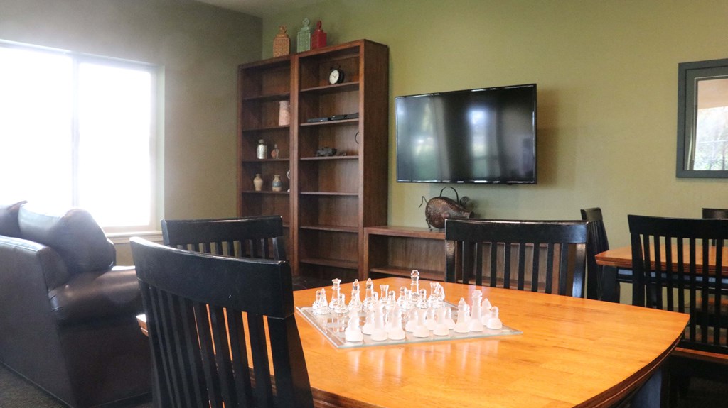 a board game table in a living room with a tv