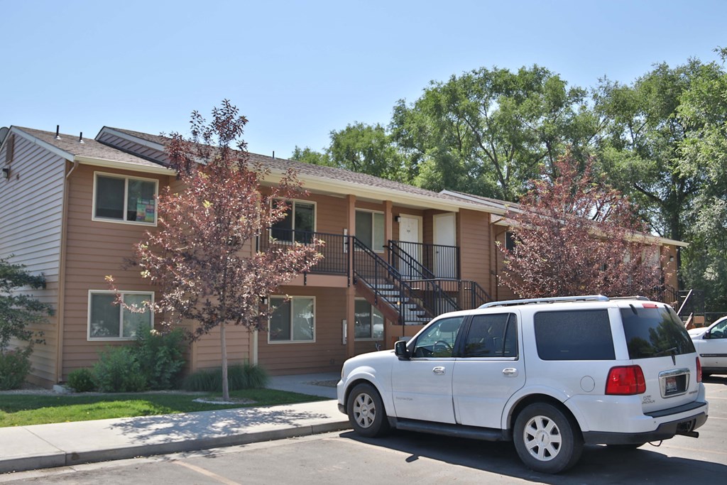 a white van parked in front of an apartment building
