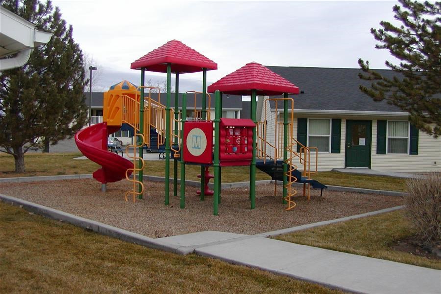 a childrens playground in front of a house