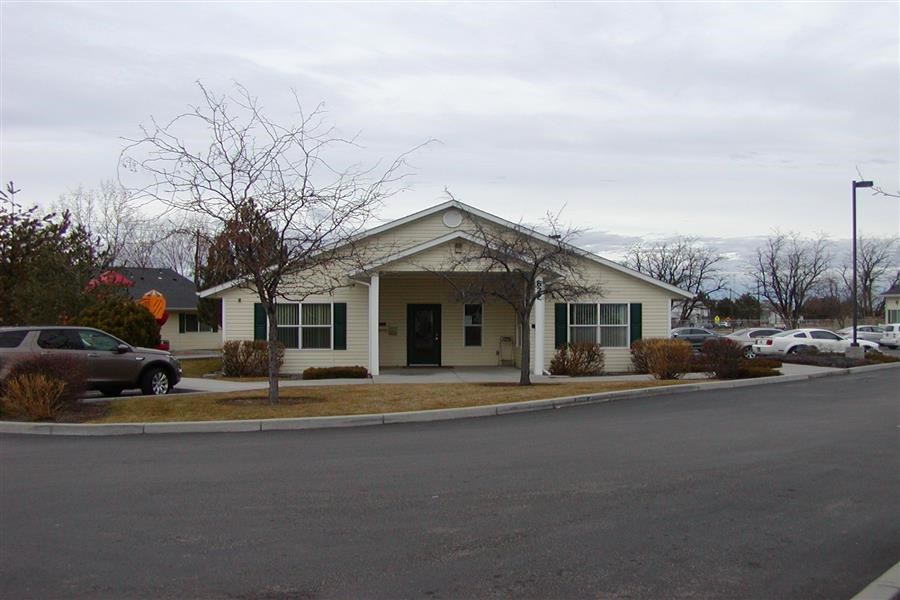 a small house on the corner of a street