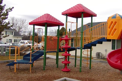 a playground with a swing set and some stairs
