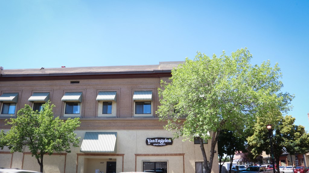 a large brick building with trees in front of it