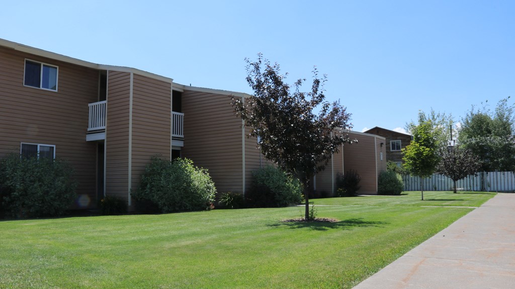 a lawn in front of an apartment building