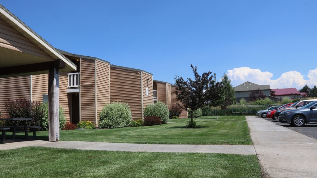 a row of buildings with cars parked in front of them