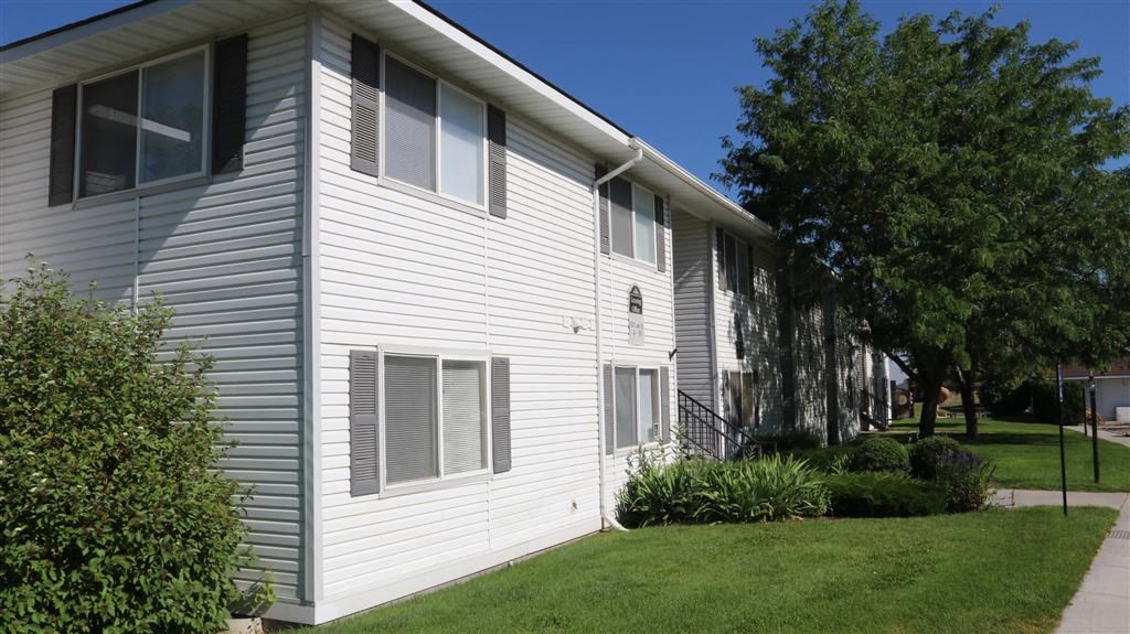 a white house with a sidewalk in front of it