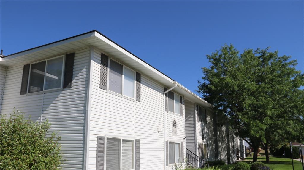 a white house with a tree in front of it