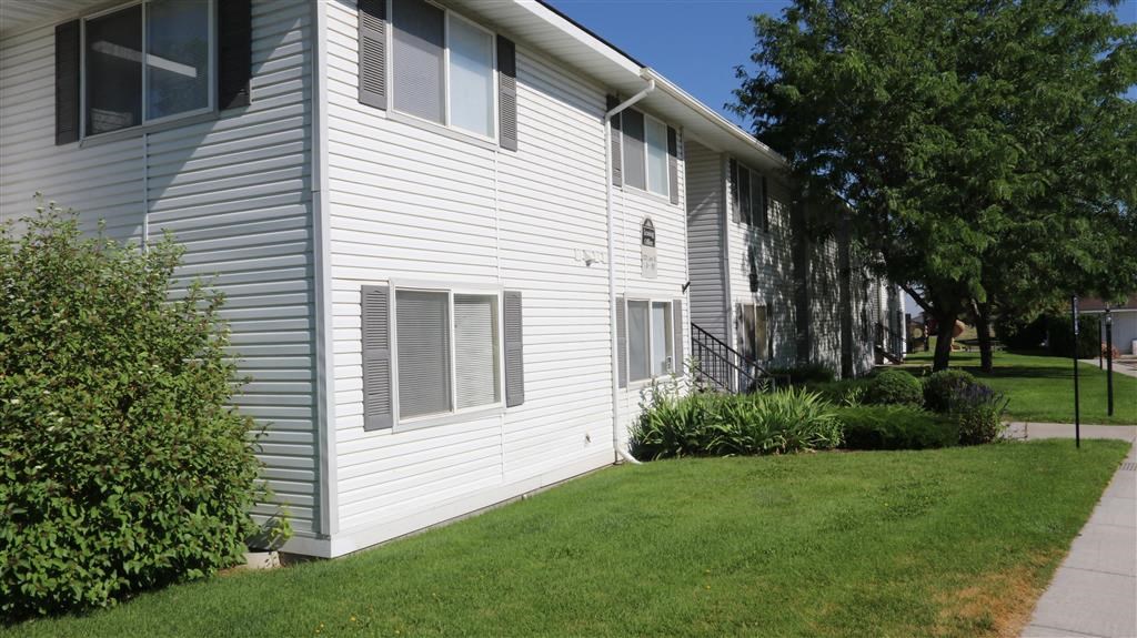 a white house with a lawn in front of it