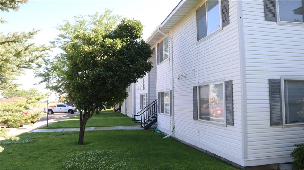 a white house with a tree in front of it