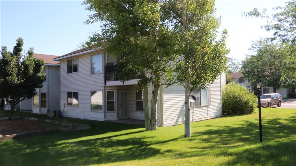 a white house with trees in front of it