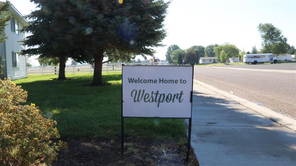 a welcome sign on the side of a street