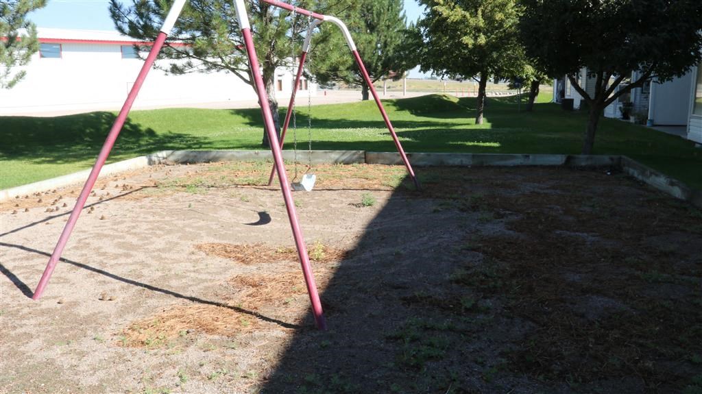 a swing set in the middle of a playground