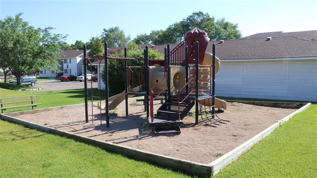 a playground with a slide and other toys in a yard