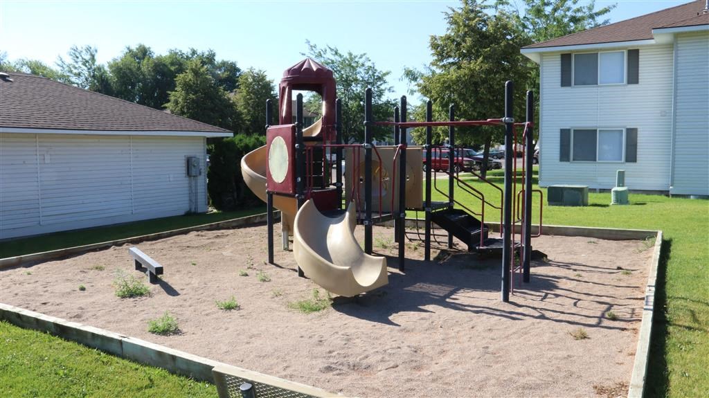 a playground with a slide and other playground equipment