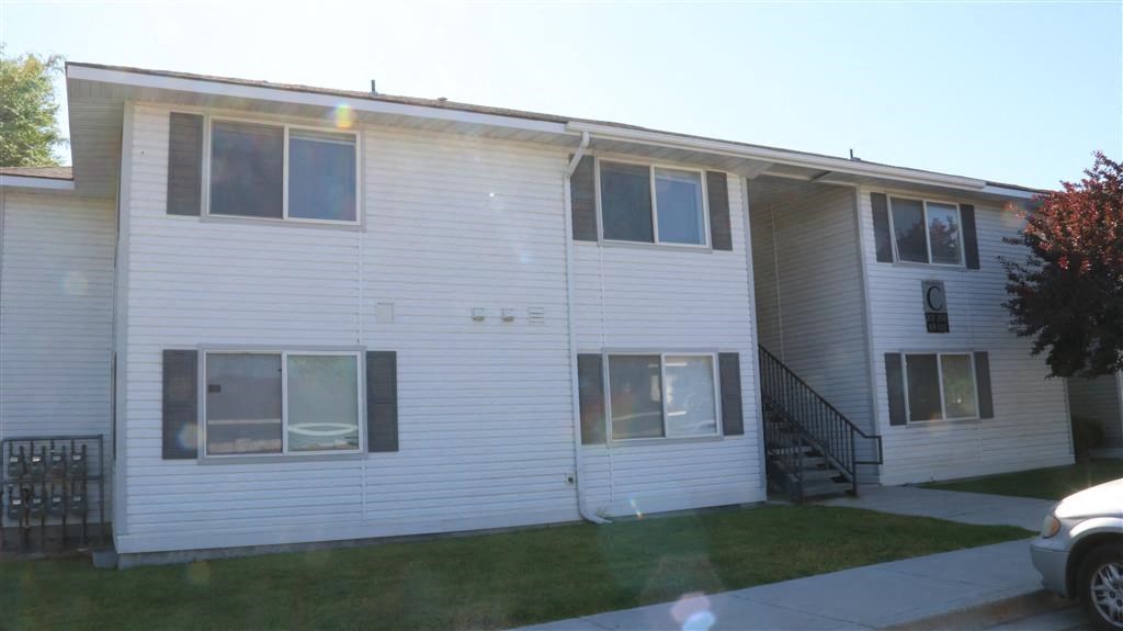 a white house with a yard in front of it