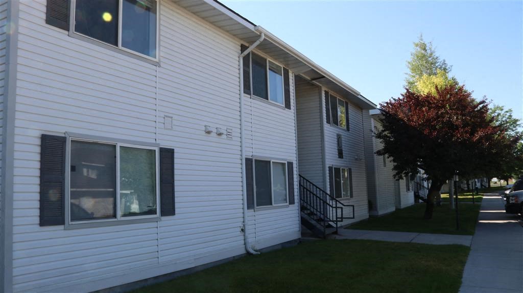 a white house with a sidewalk in front of it