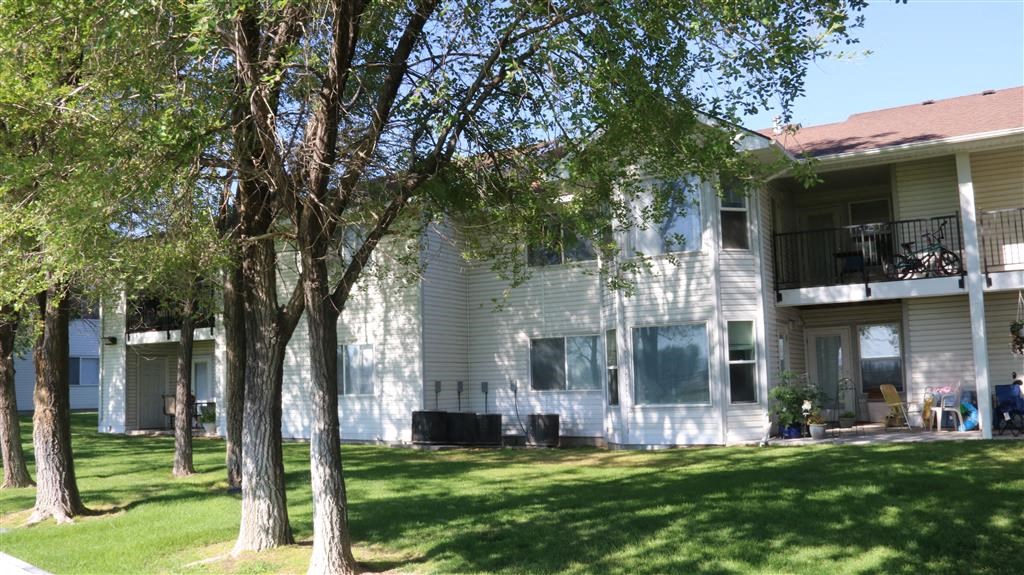 a white house with trees in front of it