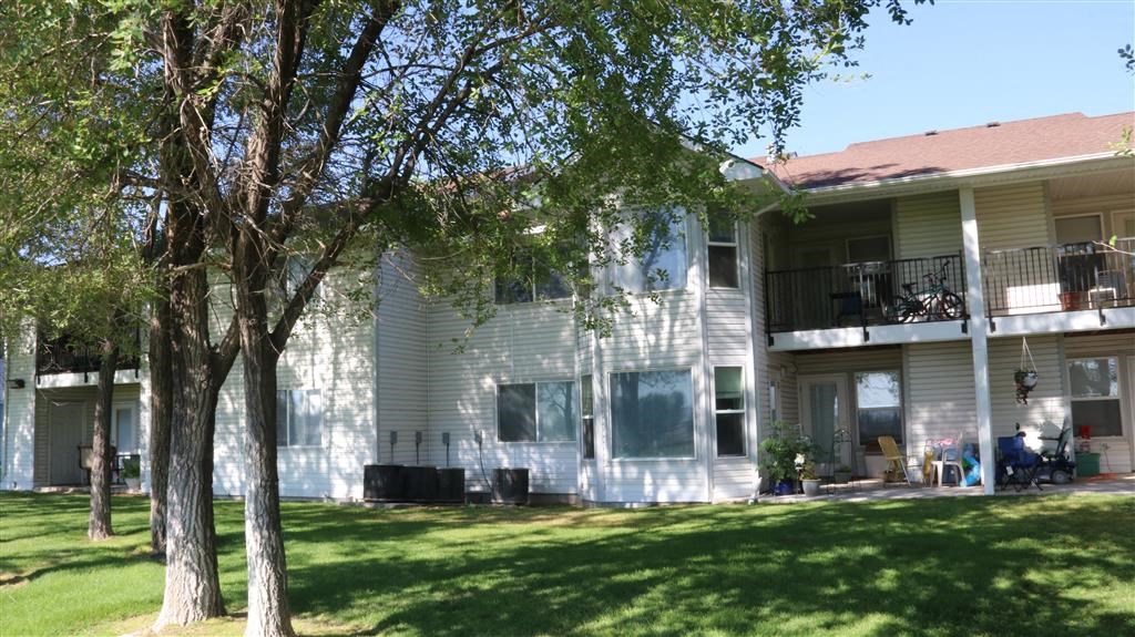 a white house with trees in front of it