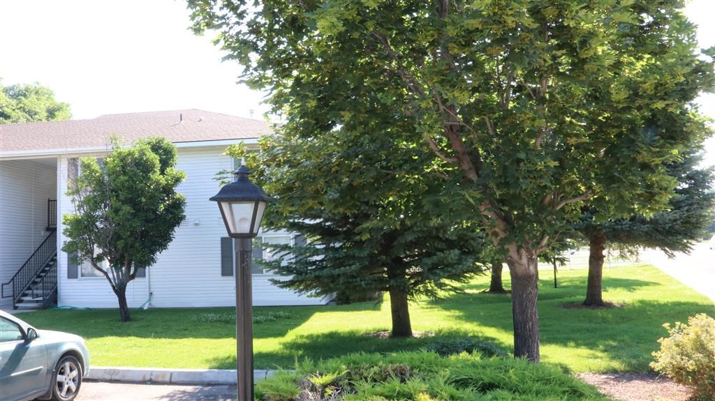 a white house with a lamp post in the front yard