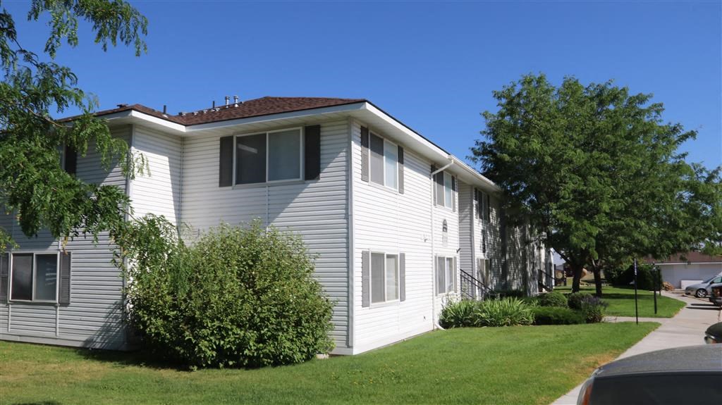 a white house with a yard in front of it