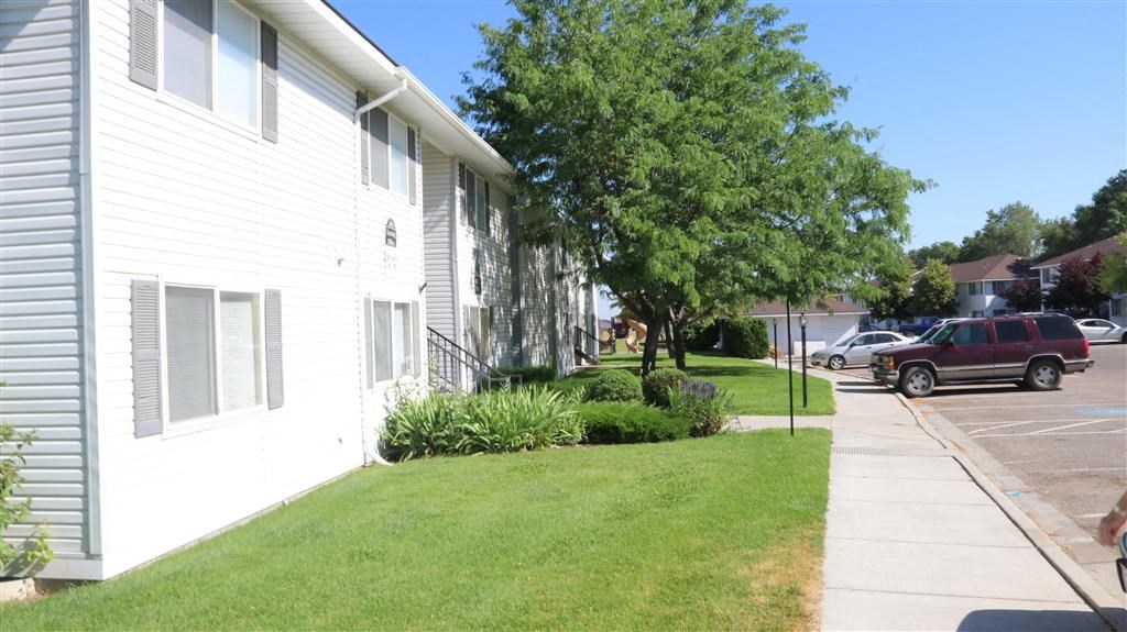 a white house with a yard and a sidewalk