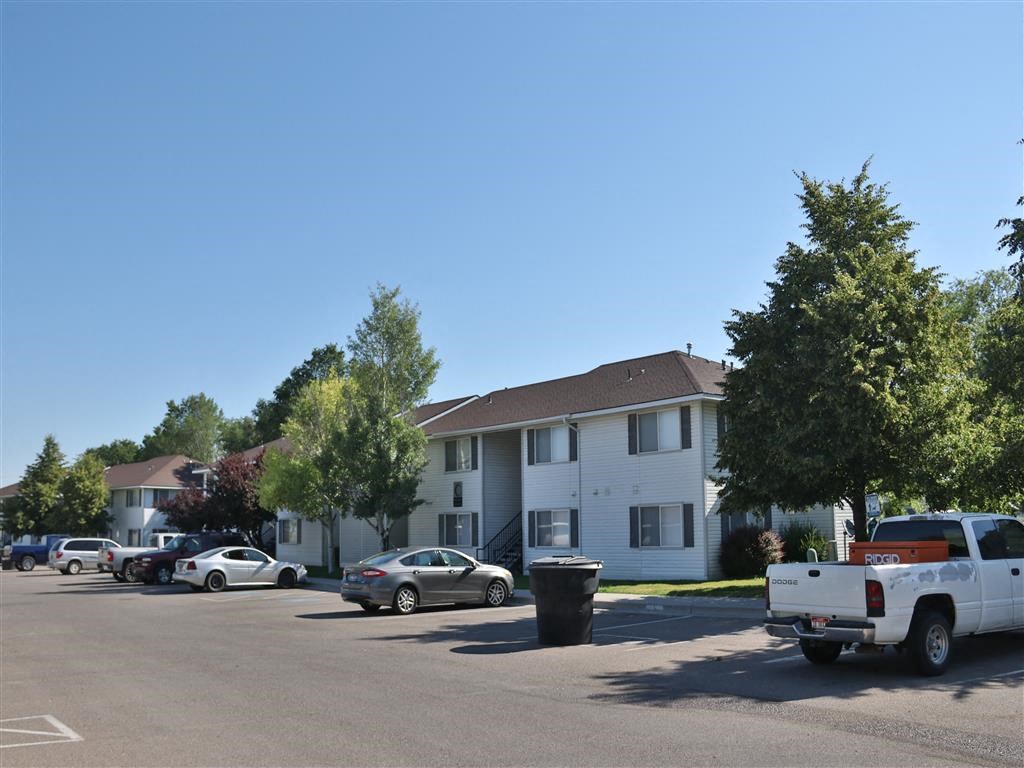 an empty parking lot in front of an apartment building
