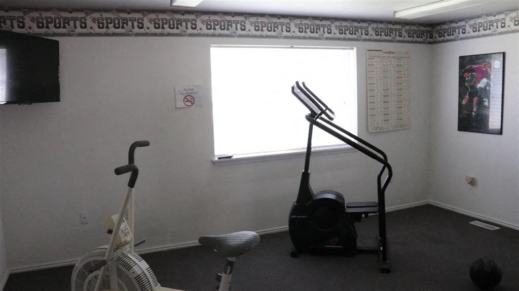 a gym room with a exercise bike and a window