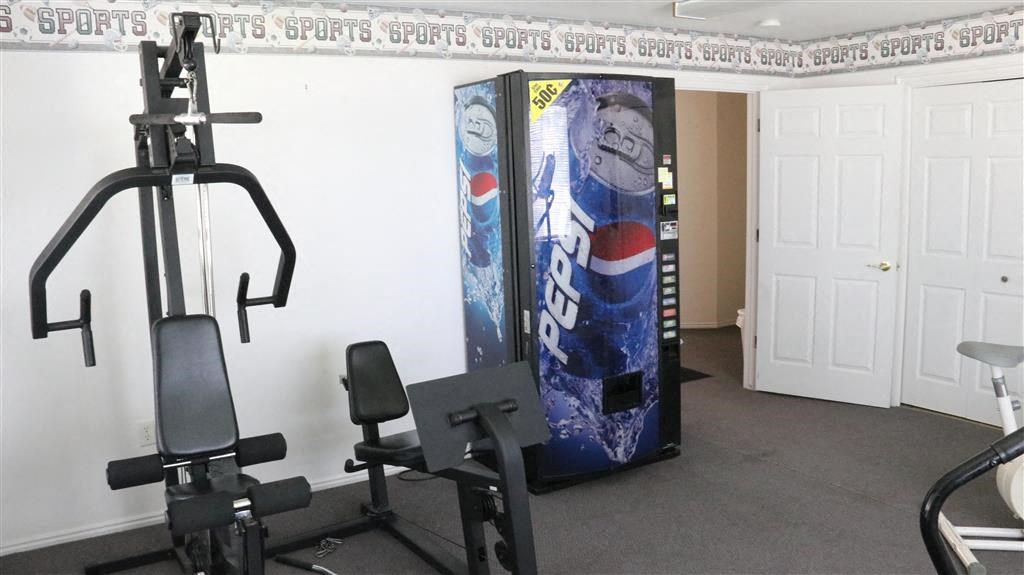 a gym with a pepsi vending machine and exercise equipment