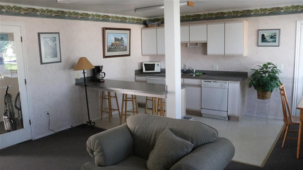 a living room with a kitchen and a couch