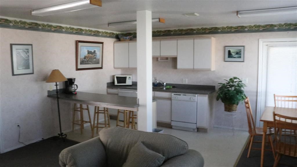 a living room with a kitchen and a table