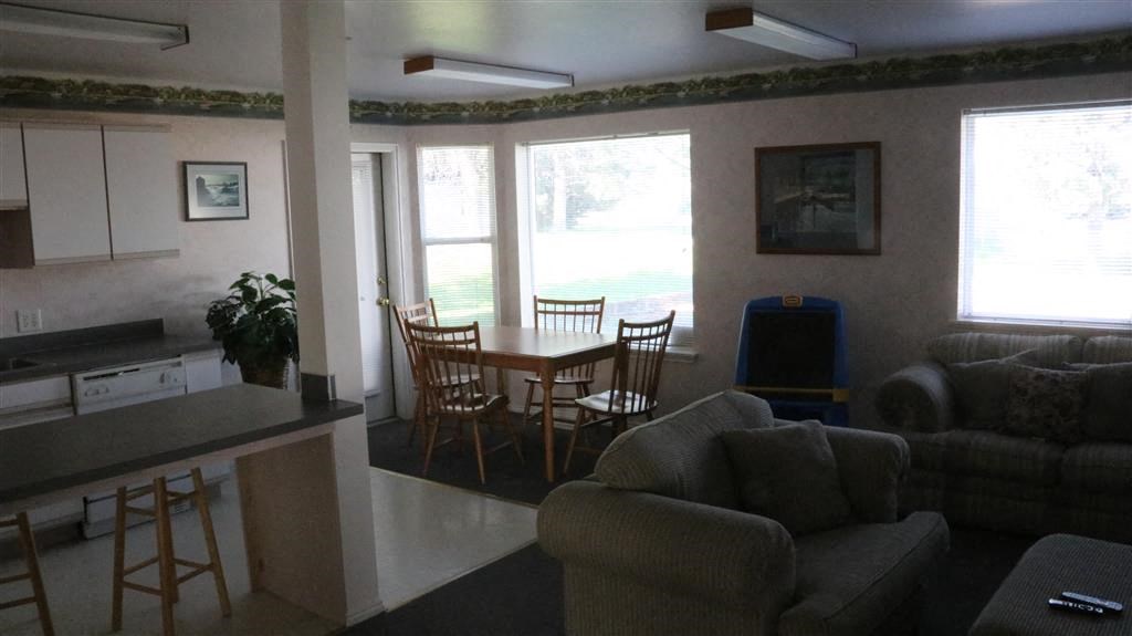 a living room and dining room with a table and chairs