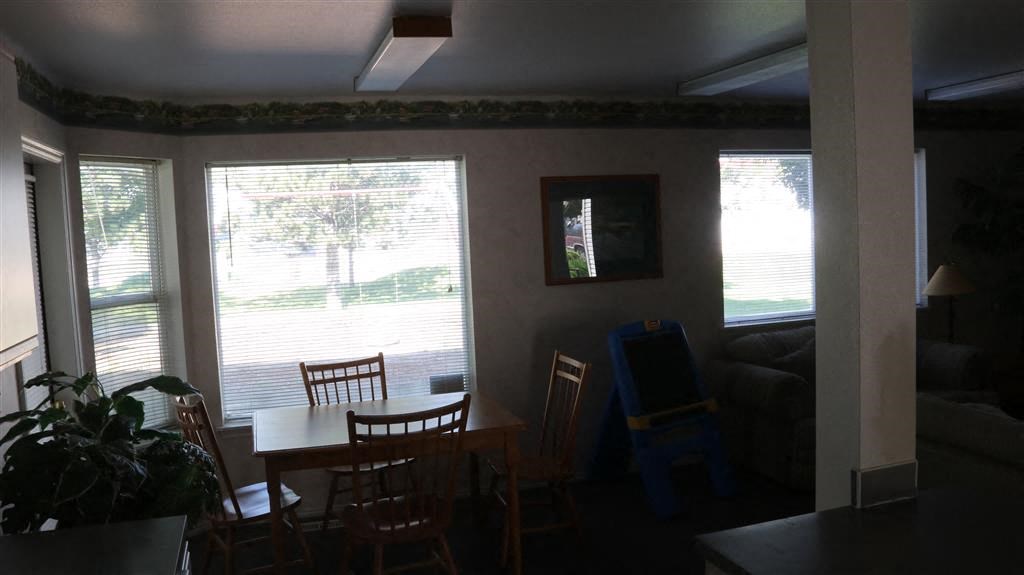 a living room with a dining room table and chairs