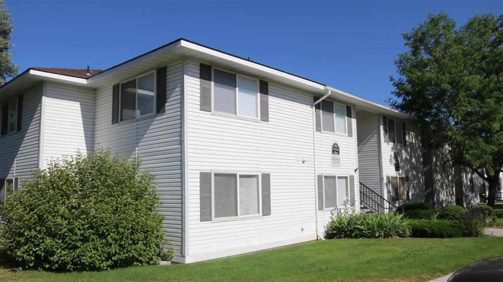 a white house with a lawn in front of it