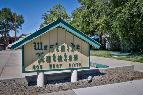 a sign for the city of 89th street sits on the side of a sidewalk