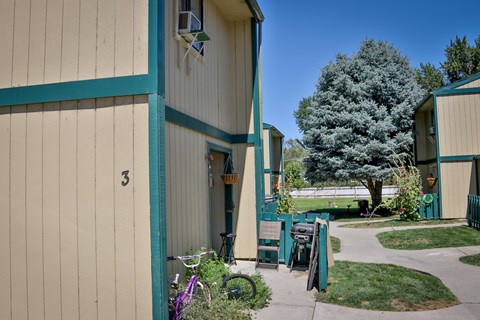 the side of a building with a sidewalk and a bike parked outside