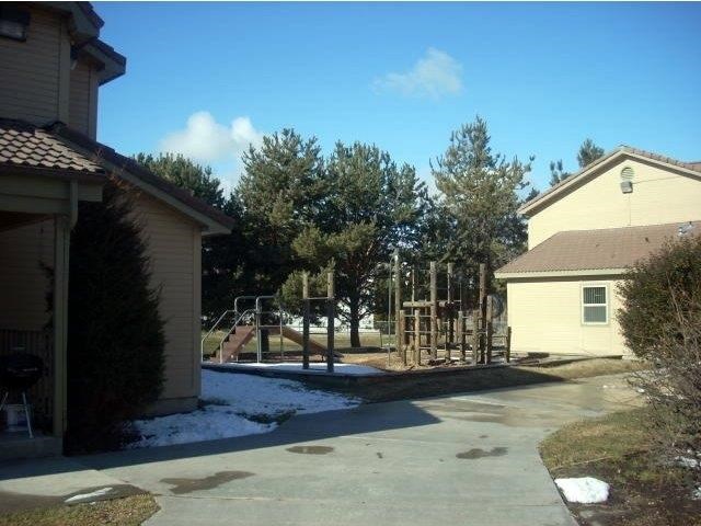 a backyard with a playground and a house