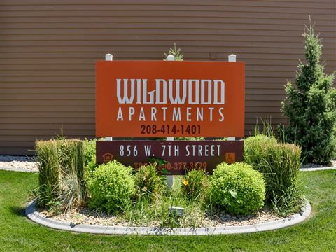 a sign for willow apartments in front of a building