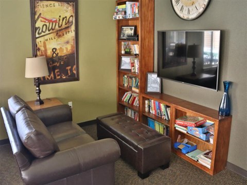 a living room with a leather couch and a tv