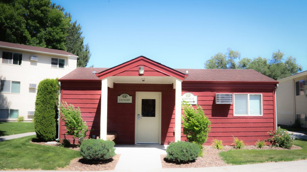the front of a red building with a white door