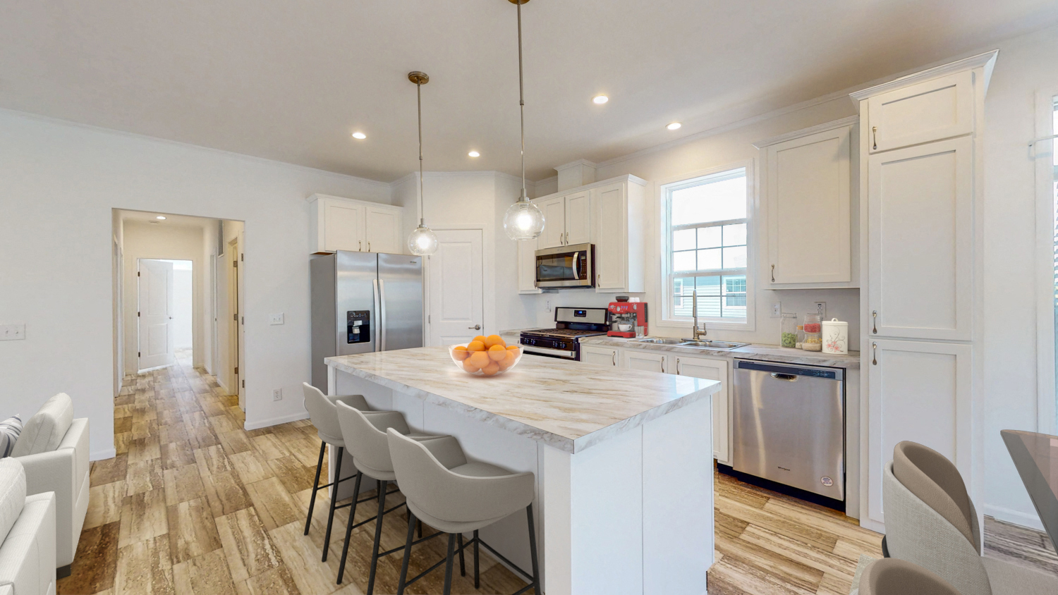 a kitchen with a marble counter top and white cabinets