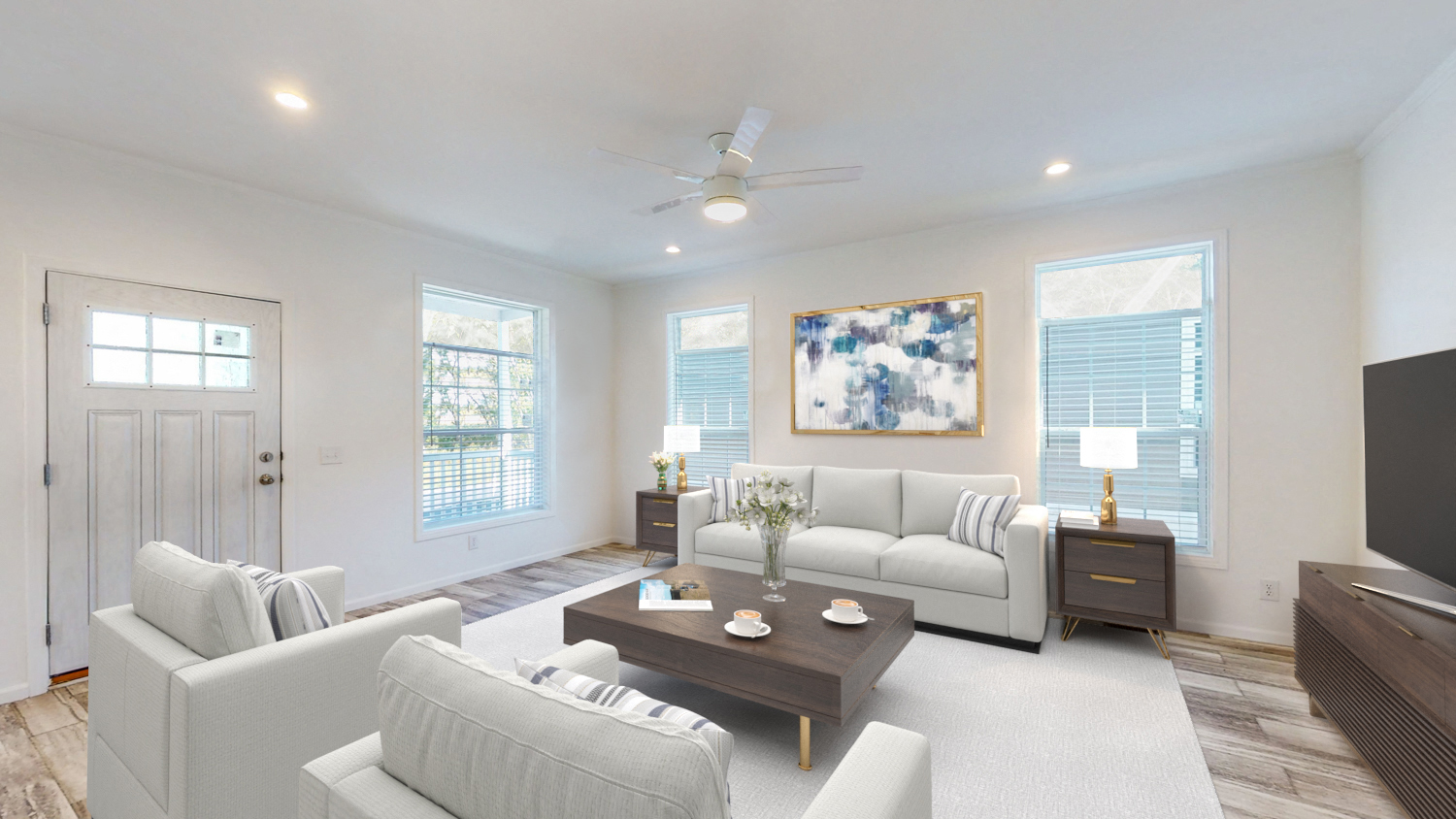 a living room with white couches and a coffee table