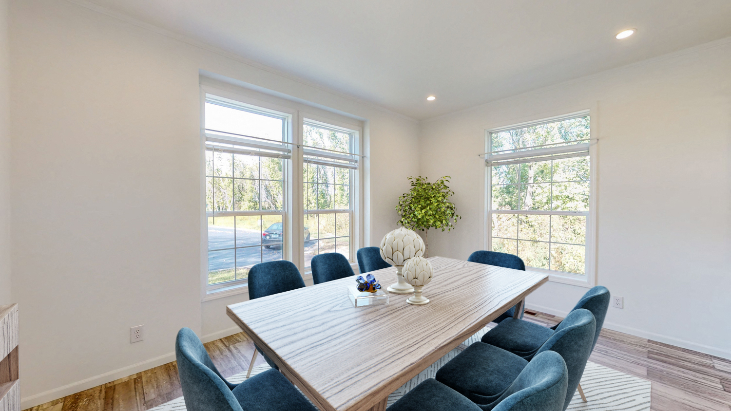 a dining room with a wooden table and blue chairs