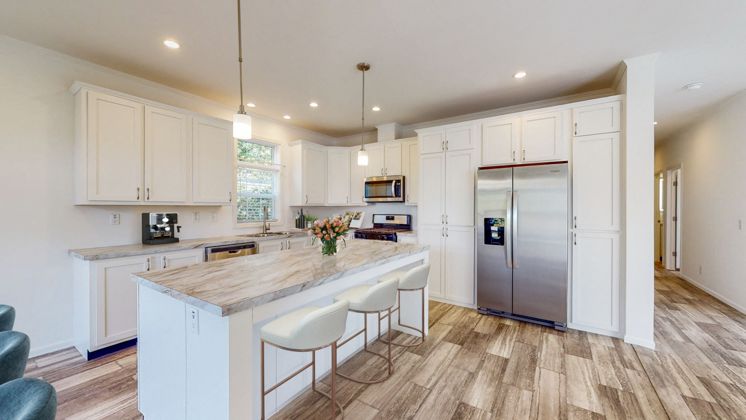 a kitchen with white cabinets and a marble counter top