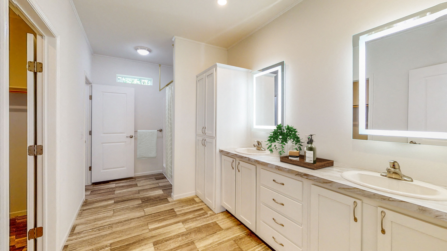 a bathroom with white cabinets and a sink and a mirror