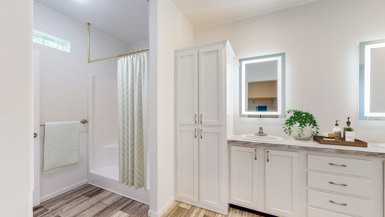 a bathroom with white cabinets and a sink and a shower