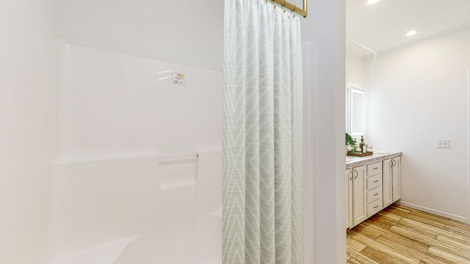 a bathroom with a shower and a sink and a shower curtain