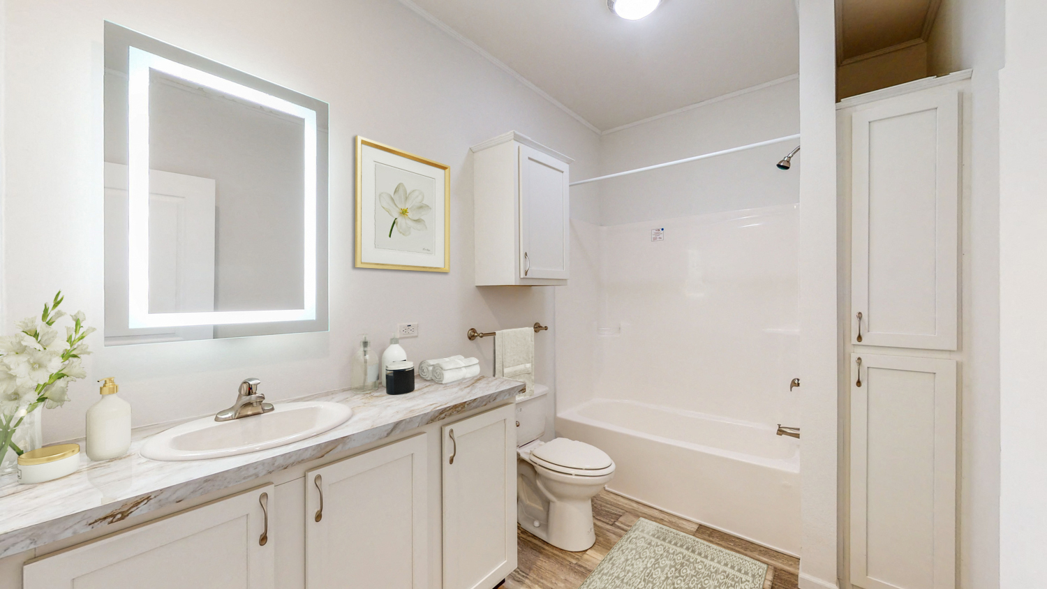 a bathroom with a sink and a toilet and a shower